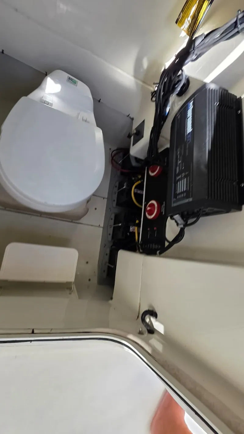 Slide: The Image of The image shows the interior of a boat with a toilet and electrical connections. - 13