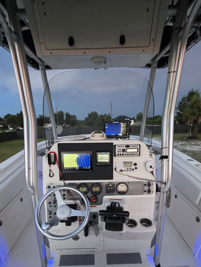 Slide: The Image of The image shows the helm of a 2006 Hydra-Sports 2500 CC boat with modern instruments. - 6