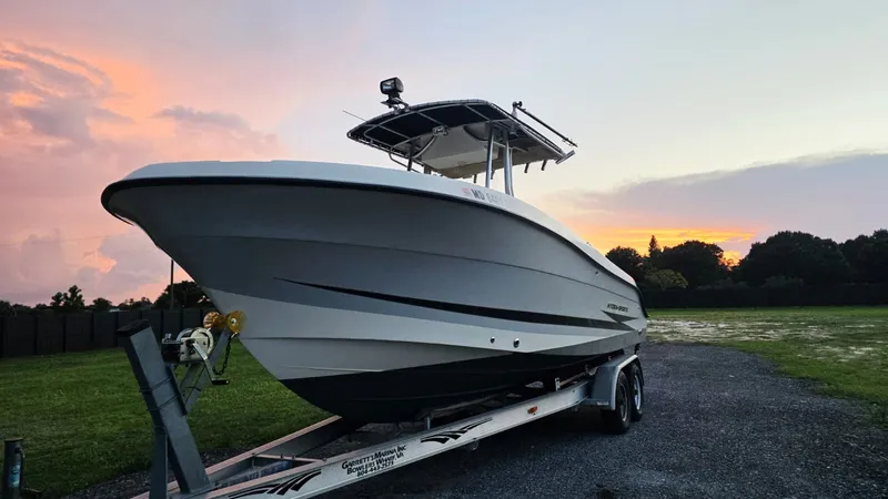Slide: The Image of A 2006 Hydra-Sports 2500 CC on a trailer, parked against a colorful sunset backdrop. - 1