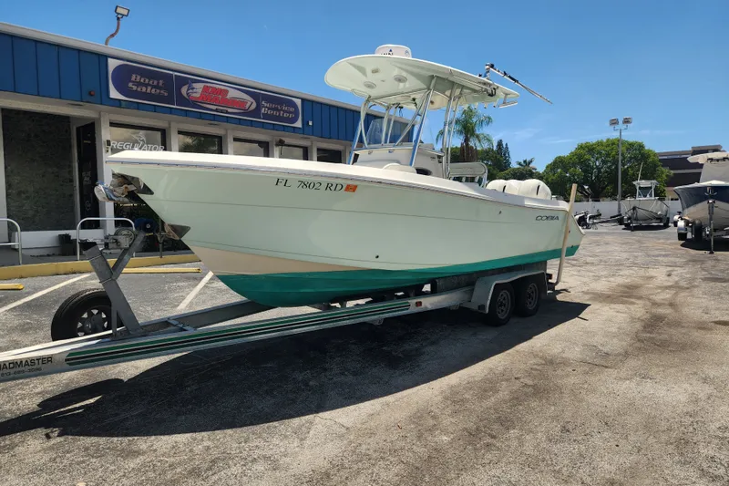 Slide: The Image of 2016 Cobia 237 Center Console boat on trailer outside sales center. - 0