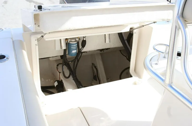 Slide: The Image of Manufacturer Provided Image: 2016 Cobia 237 Center Console boat storage compartment with visible wiring and components. - 15
