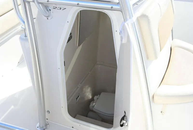 Slide: The Image of Manufacturer Provided Image: 2016 Cobia 237 Center Console boat interior with a view of the enclosed head compartment. - 11
