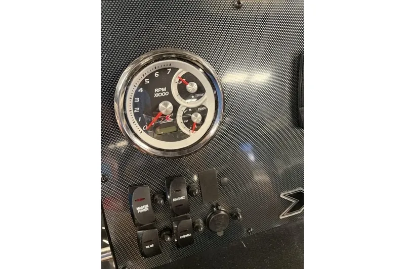 Slide: The Image of Dashboard of 2027 Xpress H20 Bay boat with RPM gauge and control switches. - 14