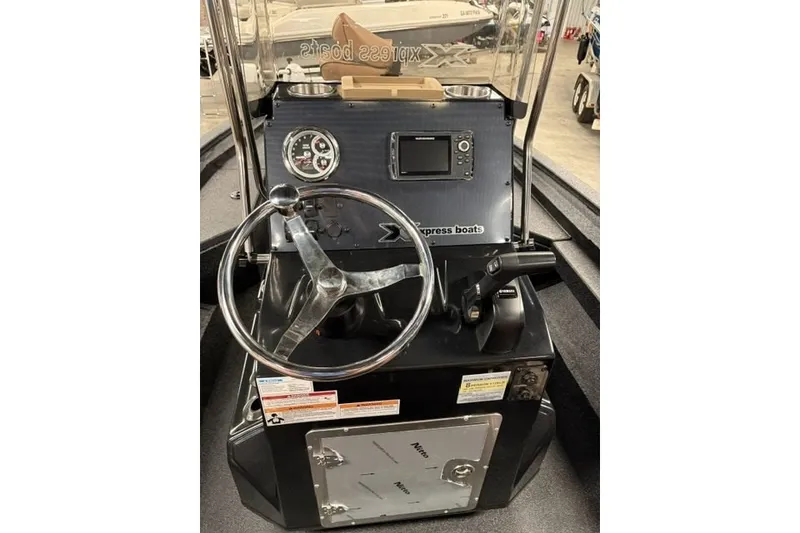 Slide: The Image of 2027 Xpress H20 Bay boat dashboard with steering wheel and control panel. - 12