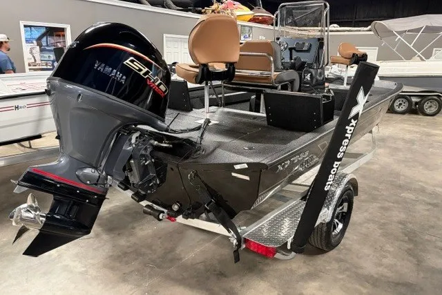Slide: The Image of 2027 Xpress H20 Bay boat with Yamaha engine on trailer in showroom. - 4