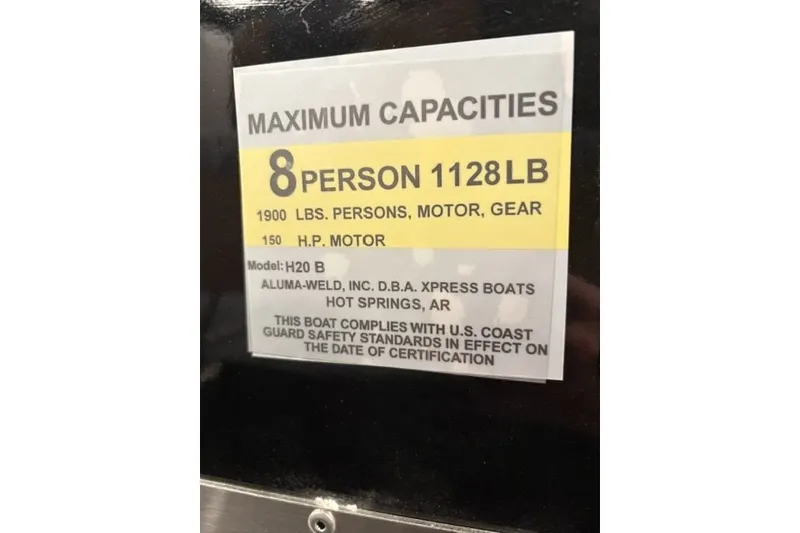 Slide: The Image of 2027 Xpress H20 Bay boat capacity label, 8 persons, 1128 lbs, 150 HP motor. - 18