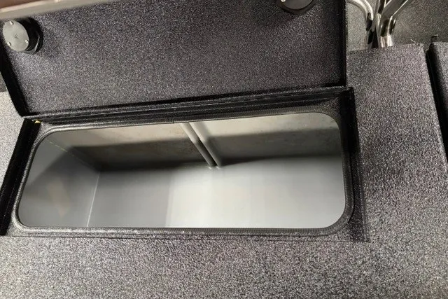Slide: The Image of 2027 Xpress H20 Bay boat storage compartment with open lid, showcasing interior space. - 16