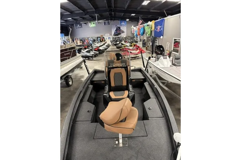 Slide: The Image of 2027 Xpress H20 Bay boat displayed in a showroom with various watercraft. - 3