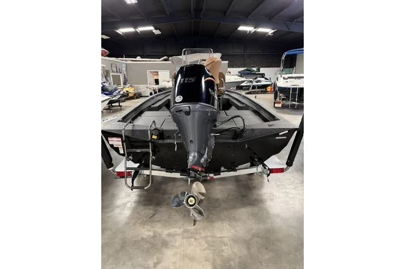Slide: The Image of 2027 Xpress H20 Bay boat with outboard motor in a showroom. - 5