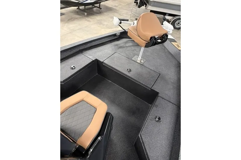Slide: The Image of 2027 Xpress H20 Bay boat interior with tan seating and storage compartments. - 8