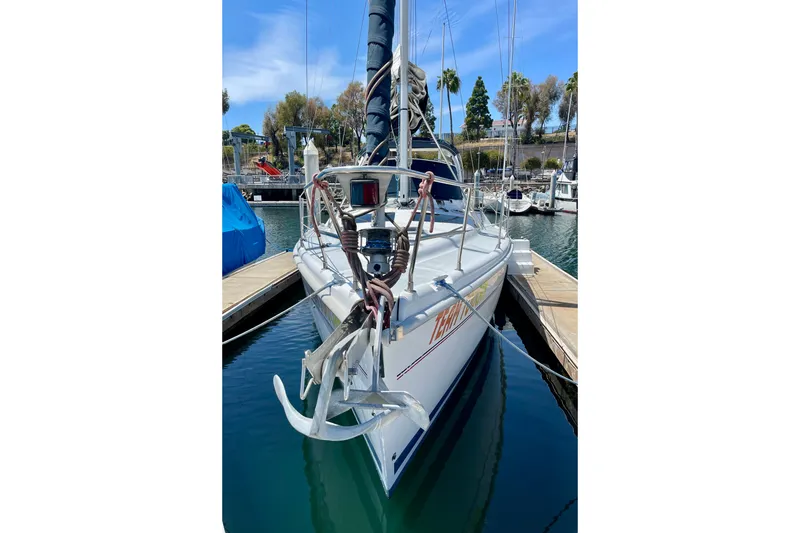 Slide: The Image of 1999 Hunter Passage 420 sailboat docked in marina, front view with anchor. - 2