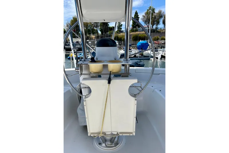 Slide: The Image of Cockpit view of 1999 Hunter Passage 420 sailboat with steering wheel and marina background. - 22