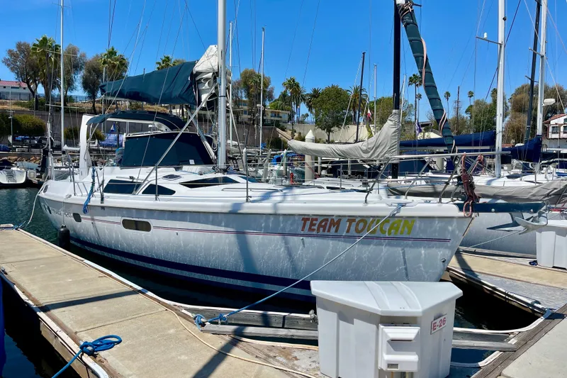 Slide: The Image of Sailboat "Team Toucan" docked, 1999 Hunter Passage 420, sunny marina setting. - 1