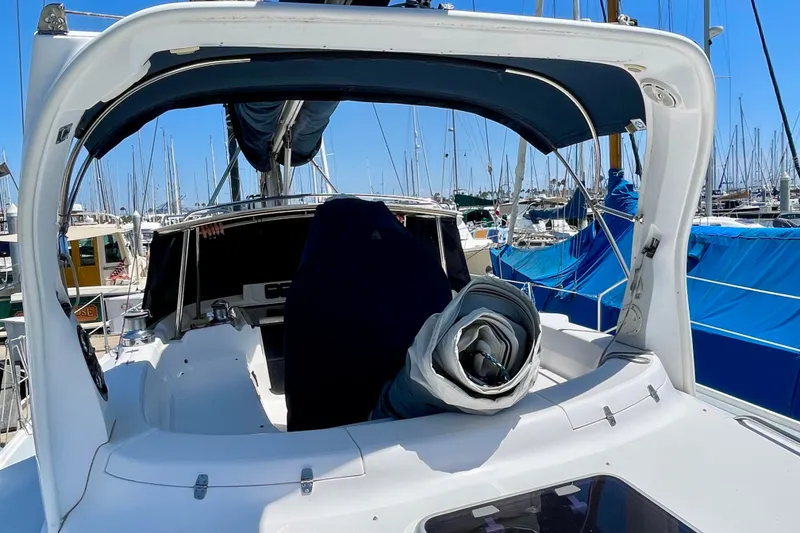 Slide: The Image of Sailboat cockpit of 1999 Hunter Passage 420 in marina, with rolled sail and canopy. - 17