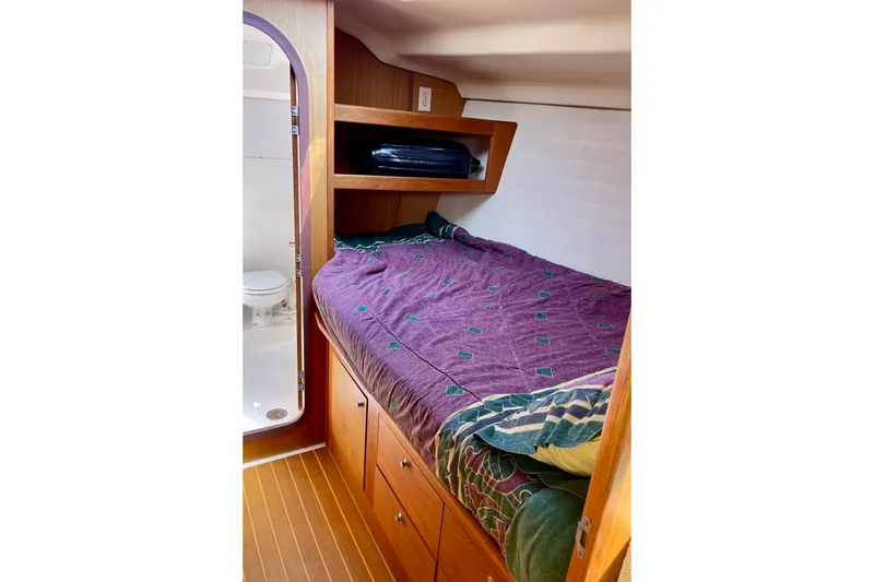 Slide: The Image of Cozy cabin interior of 1999 Hunter Passage 420 sailboat with bed and bathroom. - 46