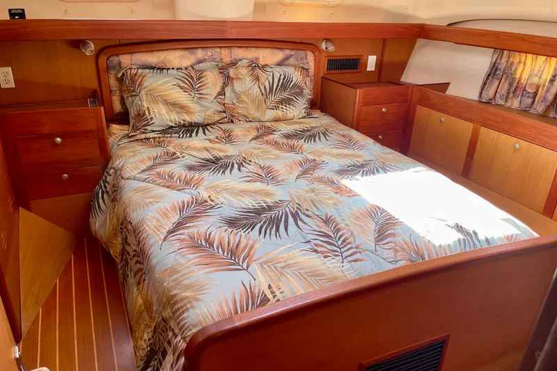 Slide: The Image of Cozy cabin interior of 1999 Hunter Passage 420 sailboat with tropical bedding. - 40