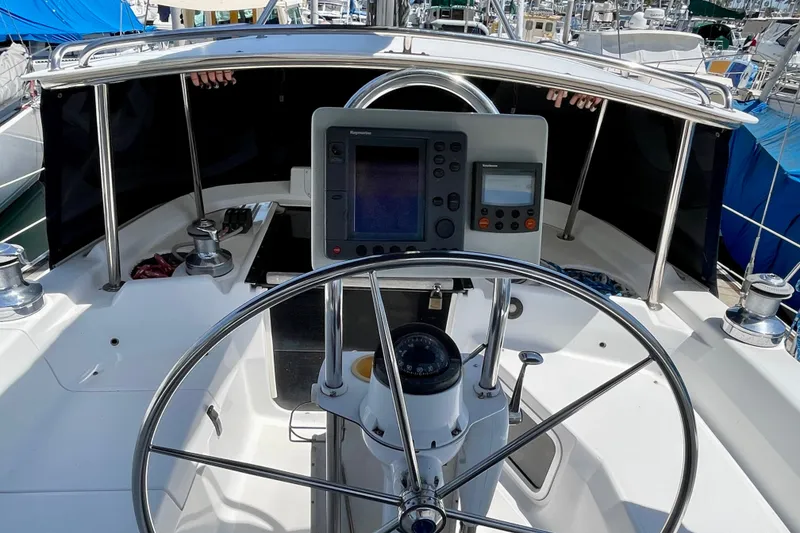 Slide: The Image of Cockpit of 1999 Hunter Passage 420 sailboat with steering wheel and navigation instruments. - 19