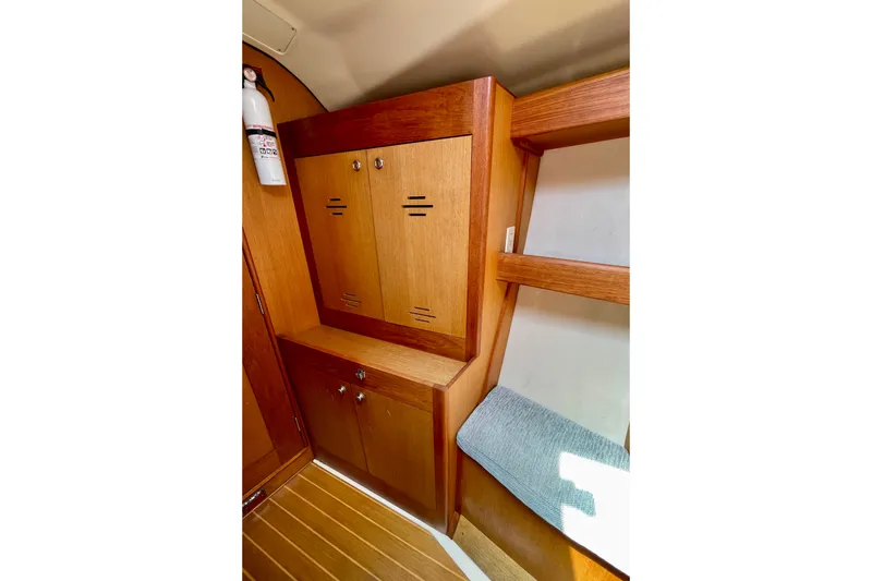 Slide: The Image of Interior of 1999 Hunter Passage 420 yacht with wooden cabinets and seating. - 49