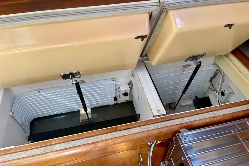 Slide: The Image of Open storage compartments in a 1999 Hunter Passage 420 yacht interior. - 29
