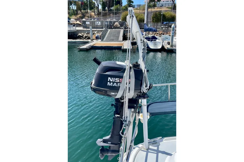 Slide: The Image of Outboard motor on a 1999 Hunter Passage 420 sailboat at a marina. - 13