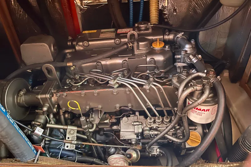 Slide: The Image of Engine compartment of a 1999 Hunter Passage 420 sailboat, showcasing detailed mechanical components. - 39