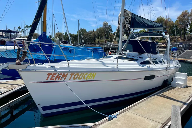 The Image of 1999 Hunter Passage 420 sailboat named "Team Toucan" docked at a marina. - 0