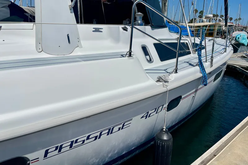 Slide: The Image of 1999 Hunter Passage 420 sailboat docked at marina, side view with clear blue sky. - 3