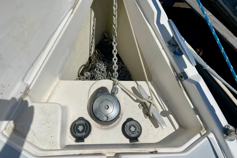 Slide: The Image of Anchor chain compartment on a 1999 Hunter Passage 420 sailboat, featuring Maxwell equipment. - 9