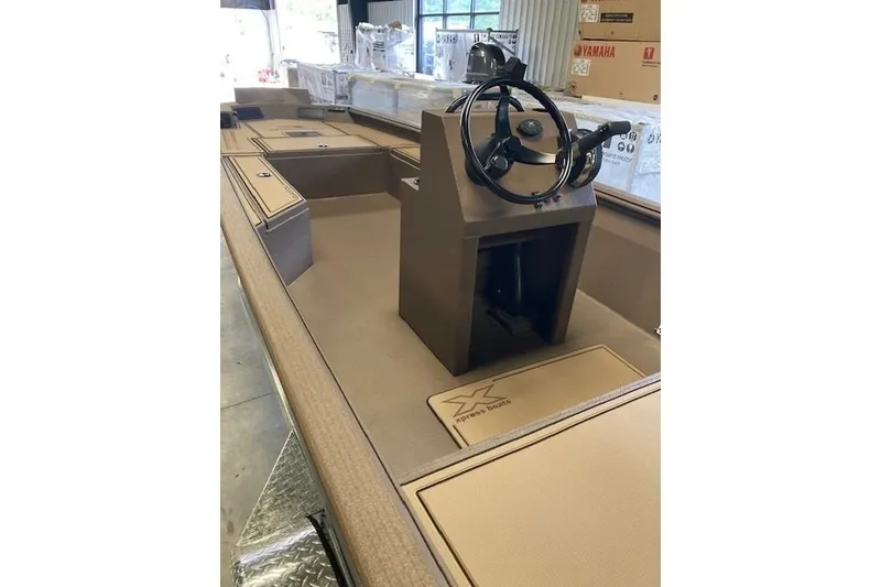 Slide: The Image of 2026 Xpress Bayou 180CC boat interior with steering console and storage compartments. - 7