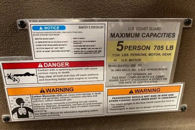 Slide: The Image of Xpress Bayou 180CC 2026 boat capacity and safety warnings label, detailing maximum load and safety precautions. - 14