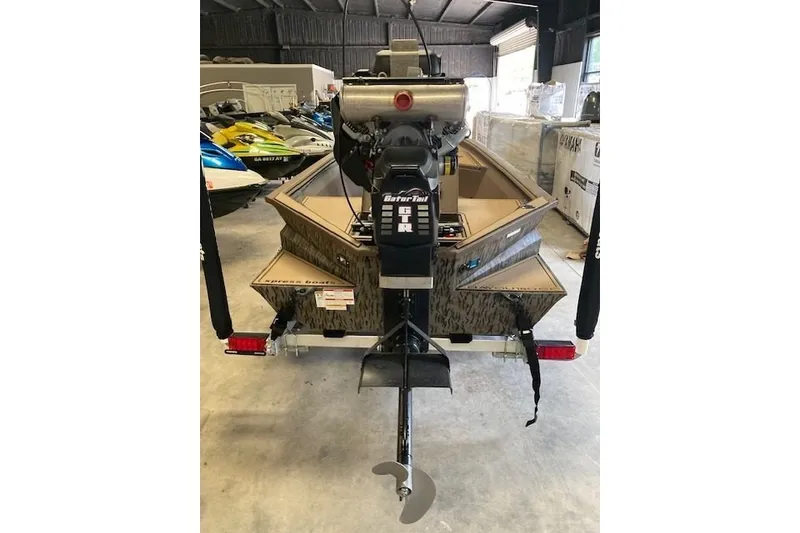 Slide: The Image of 2026 Xpress Bayou 180CC boat with Gator-Tail motor in storage facility. - 10