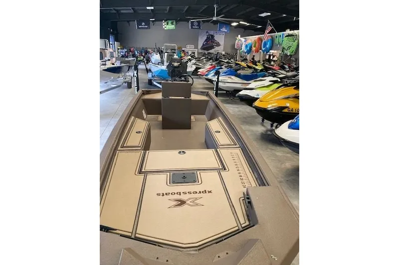 Slide: The Image of 2026 Xpress Bayou 180CC boat displayed in a showroom with various watercraft. - 4