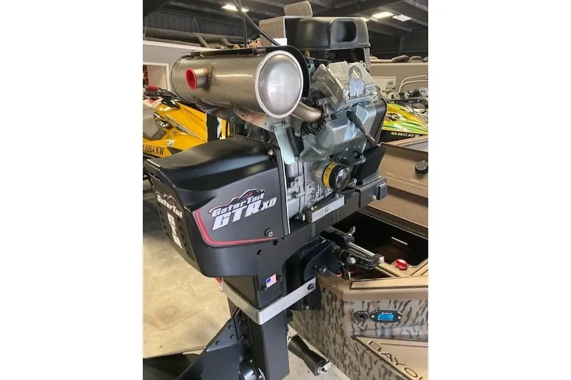 Slide: The Image of 2026 Xpress Bayou 180CC boat engine, featuring Gator Tail GTR XD motor in a showroom. - 11