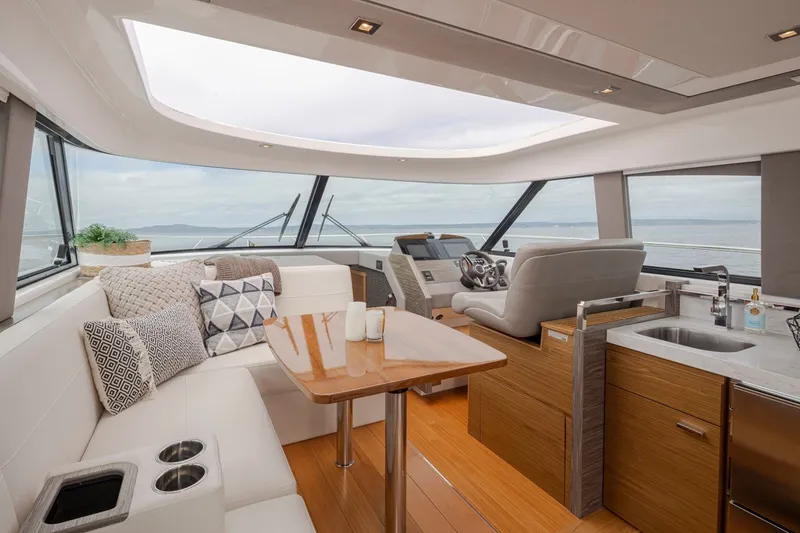 Slide: The Image of Luxurious interior of 2019 Tiara Yachts C44 Coupe with elegant seating and panoramic windows. - 7