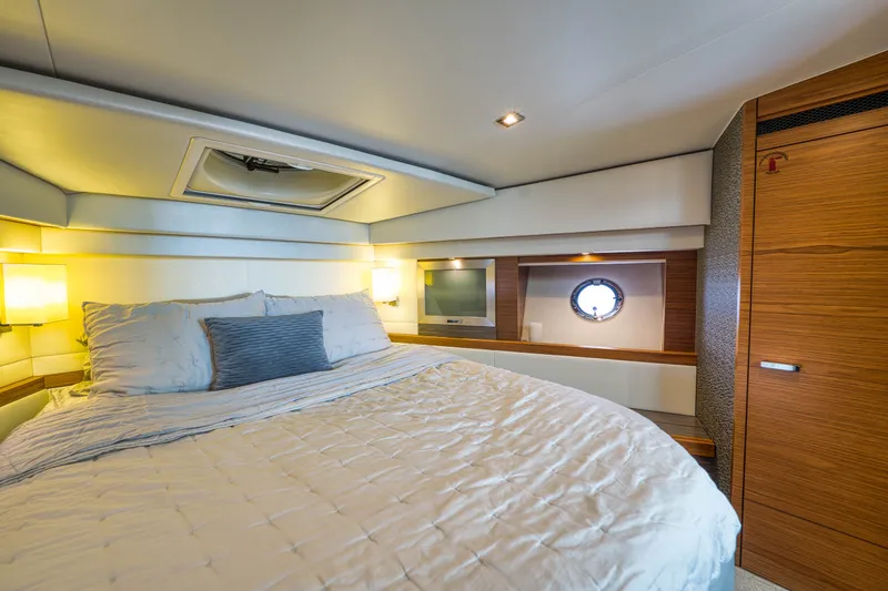 Slide: The Image of Luxurious bedroom interior of 2019 Tiara Yachts C44 Coupe with elegant wood finishes. - 28