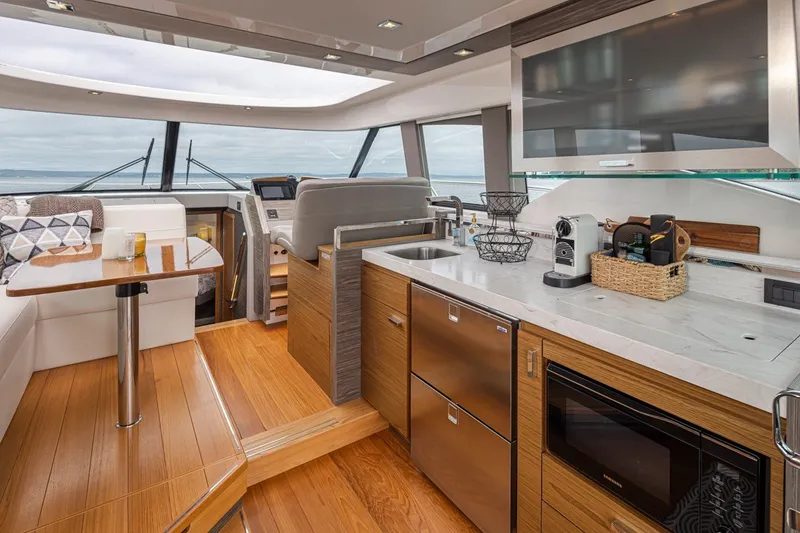 Slide: The Image of Luxurious interior of 2019 Tiara Yachts C44 Coupe with modern kitchen and seating area. - 8