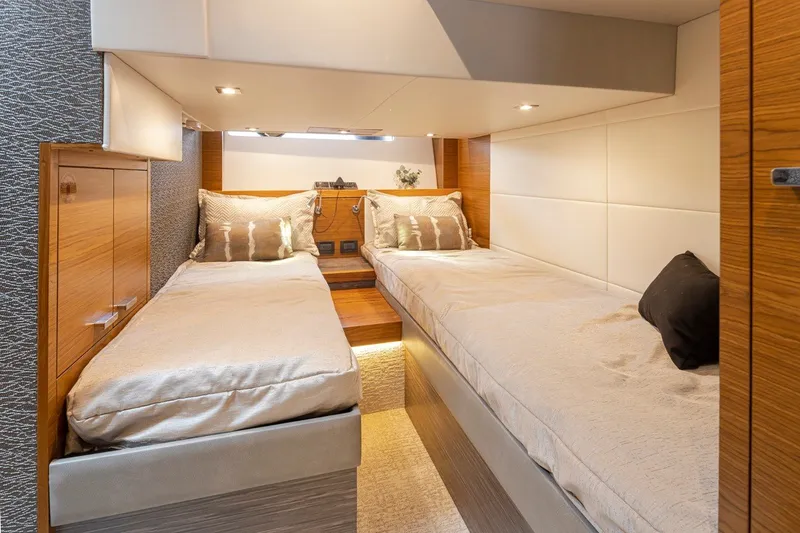Slide: The Image of Luxurious 2019 Tiara Yachts C44 Coupe cabin with twin beds and elegant wood finishes. - 25