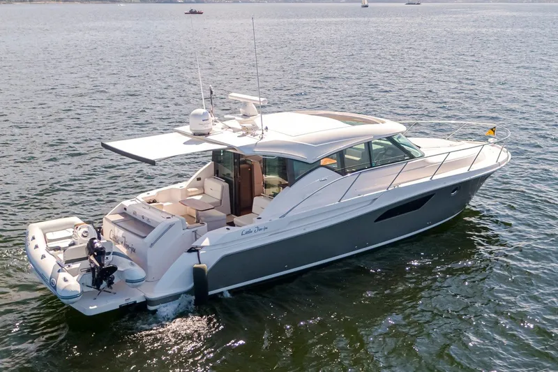 Slide: The Image of 2019 Tiara Yachts C44 Coupe cruising on open water, showcasing sleek design and luxury features. - 37