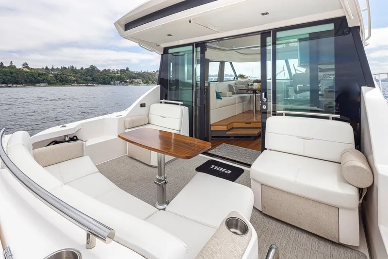 Slide: The Image of 2019 Tiara Yachts C44 Coupe with elegant outdoor seating and scenic water view. - 27