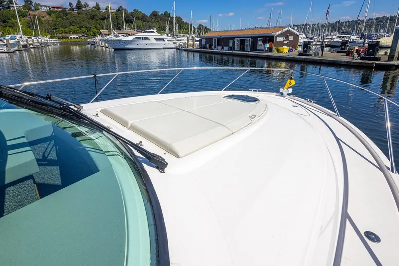 Slide: The Image of 2019 Tiara Yachts C44 Coupe docked at a marina, showcasing sleek design and spacious deck. - 56