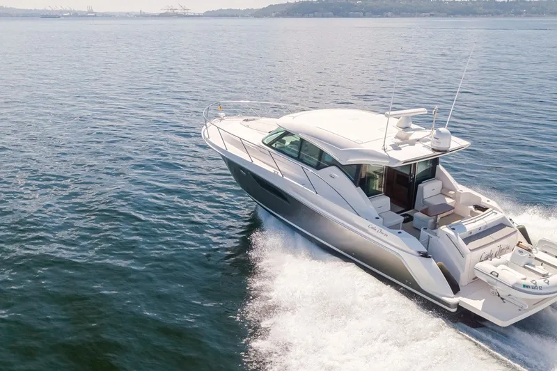 Slide: The Image of 2019 Tiara Yachts C44 Coupe cruising on open water, showcasing sleek design and luxury. - 47