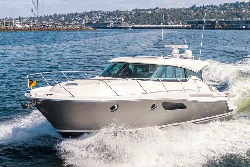 Slide: The Image of 2019 Tiara Yachts C44 Coupe cruising on open water, showcasing sleek design and performance. - 43