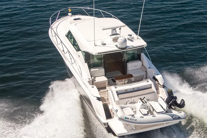 Slide: The Image of 2019 Tiara Yachts C44 Coupe cruising on open water, rear view. - 46