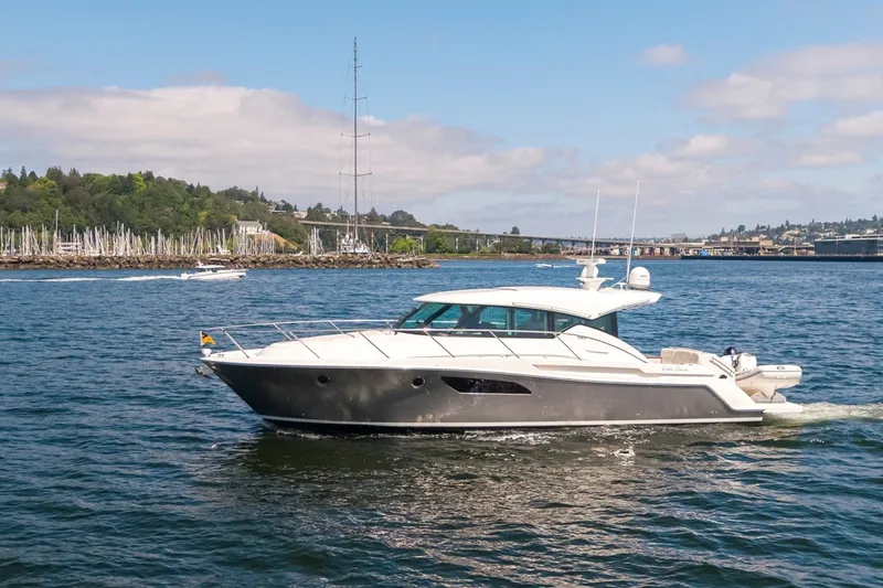 Slide: The Image of 2019 Tiara Yachts C44 Coupe cruising on a scenic waterway. - 41