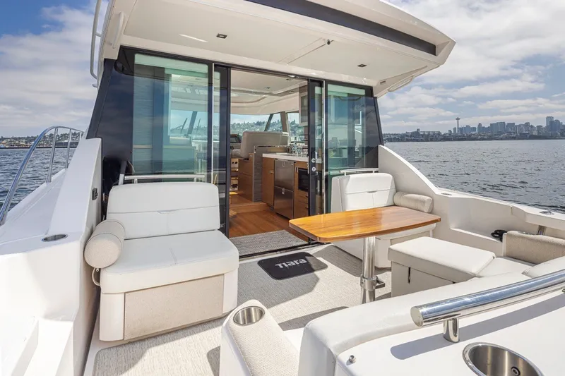 Slide: The Image of 2019 Tiara Yachts C44 Coupe with elegant seating and scenic waterfront view. - 34
