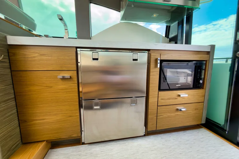 Slide: The Image of Modern kitchen area in 2019 Tiara Yachts C44 Coupe with stainless steel appliances. - 14