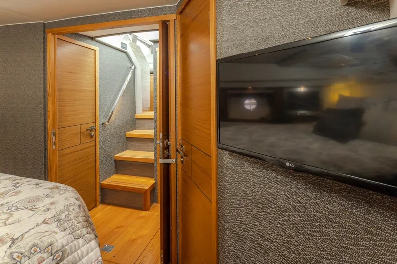 Slide: The Image of Interior of 2019 Tiara Yachts C44 Coupe with stairs, TV, and wooden doors. - 21