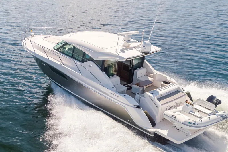 Slide: The Image of 2019 Tiara Yachts C44 Coupe cruising on open water, rear view. - 3