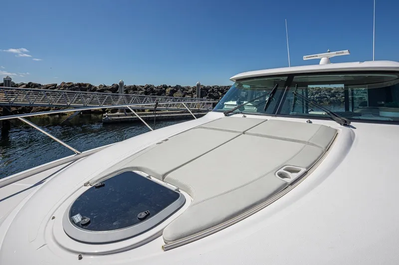 Slide: The Image of 2019 Tiara Yachts C44 Coupe docked, showcasing sleek design and spacious deck. - 55