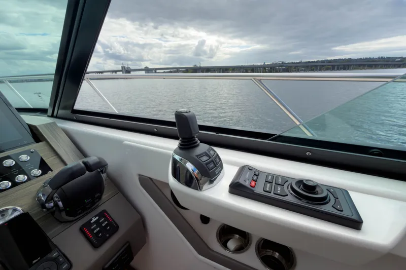 Slide: The Image of 2019 Tiara Yachts C44 Coupe helm with controls and water view. - 22